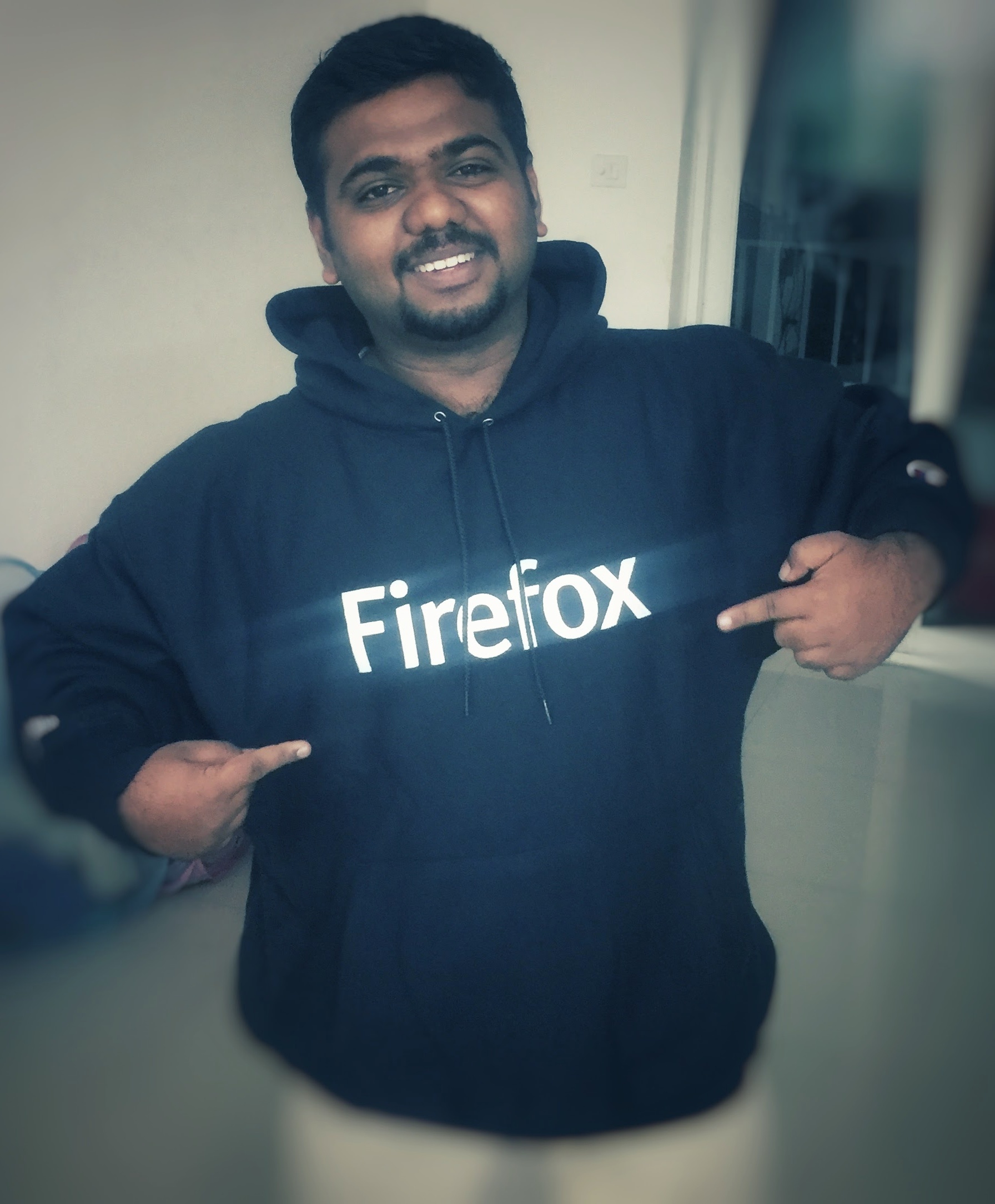 A picture of a smiling Viswaprasath Ks wearing a Firefox hoodie