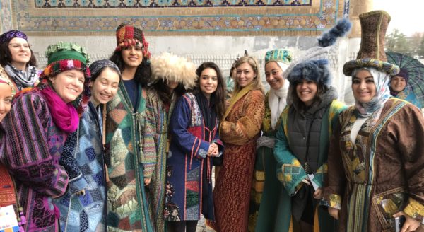 Kathy with a group of Uzbek women wearing traditional colourful clothing