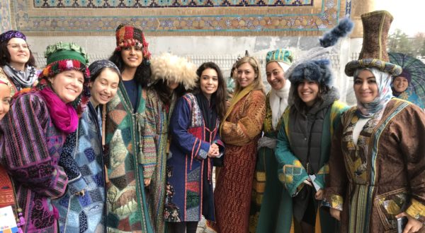 Kathy with a group of Uzbek women wearing traditional colourful clothing