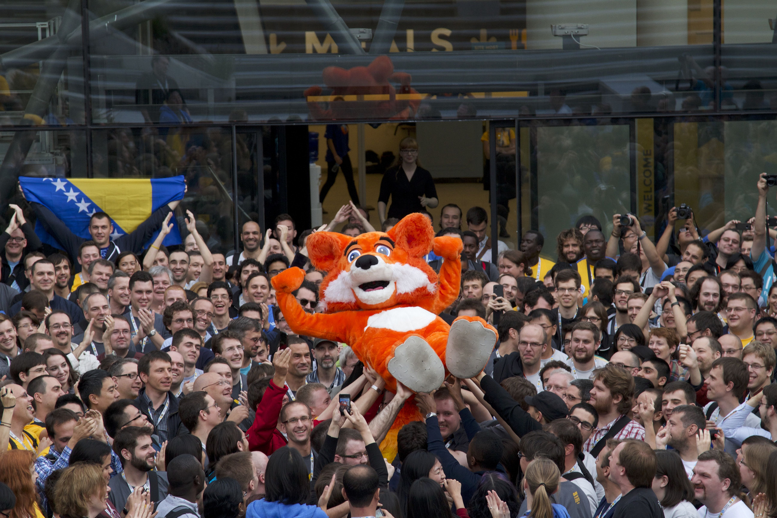 The "Foxy" mascot is held aloft by attendees of the Mozilla 2013 Summit in Brussels