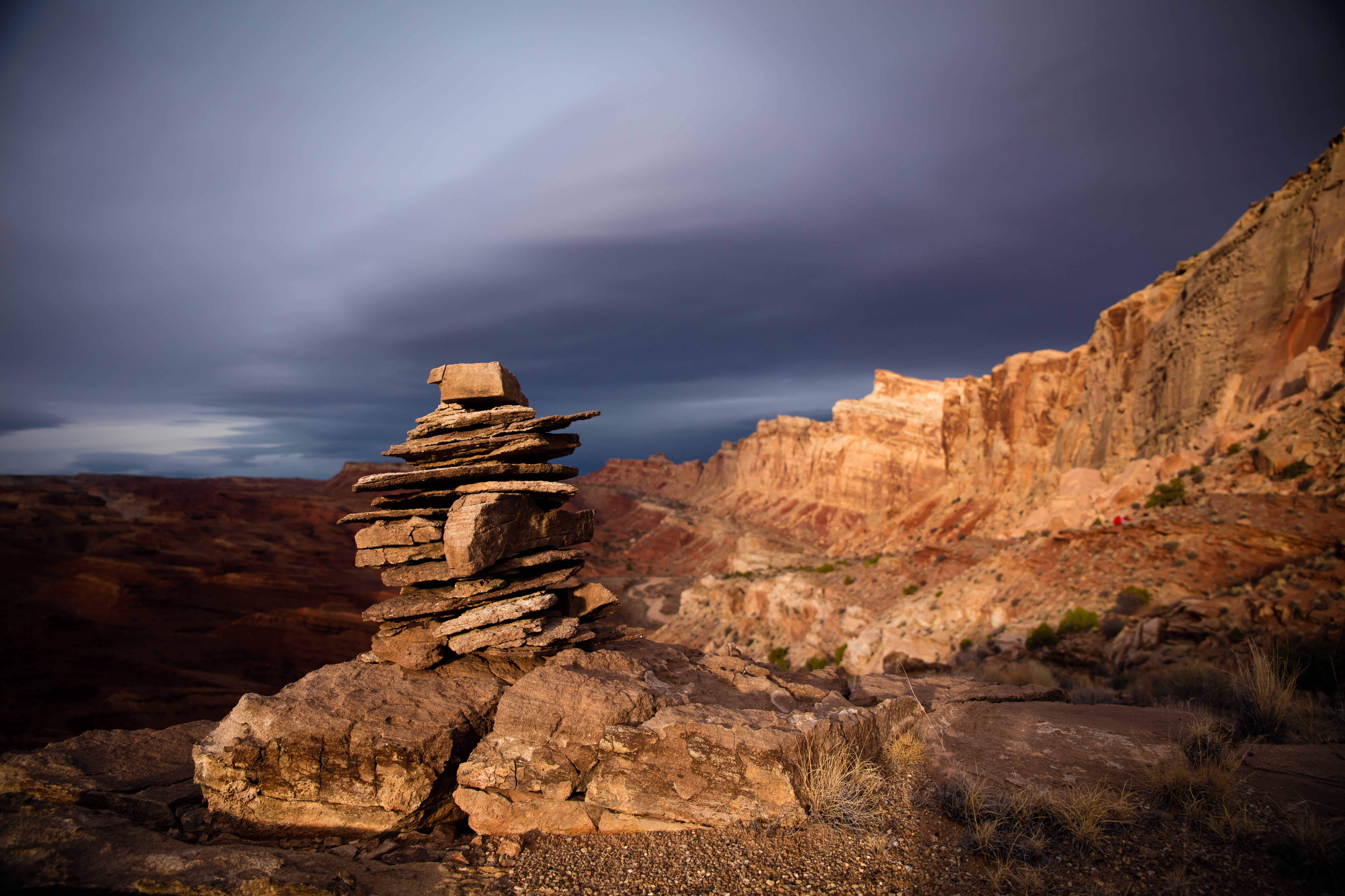 A stacked group of stones sits atop a mountain background