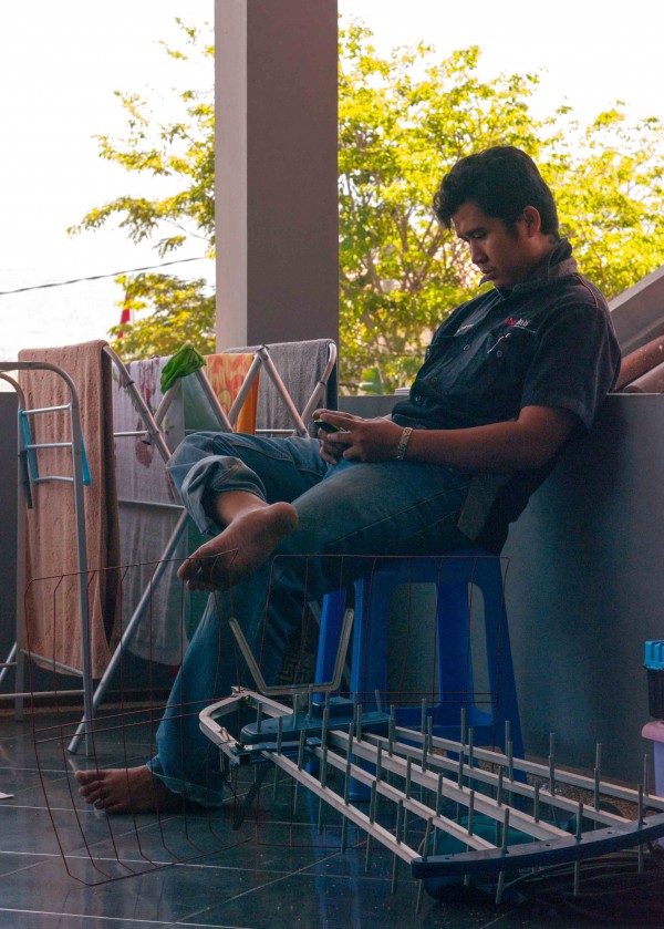 Air Conditioning Repairman Taking a Break with his Smartphone