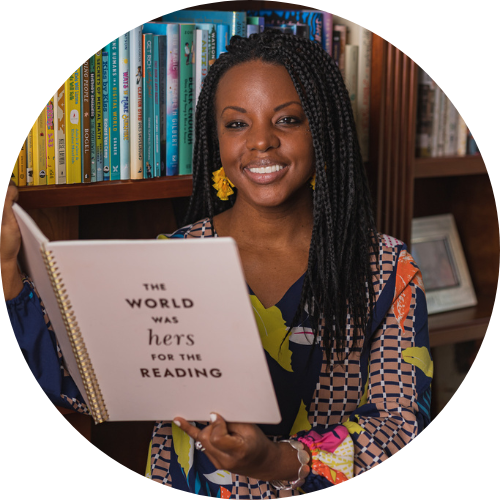 Charnaie Gordon holds up a book in front of a bookshelf. The book cover reads: "The world was hers for the reading."