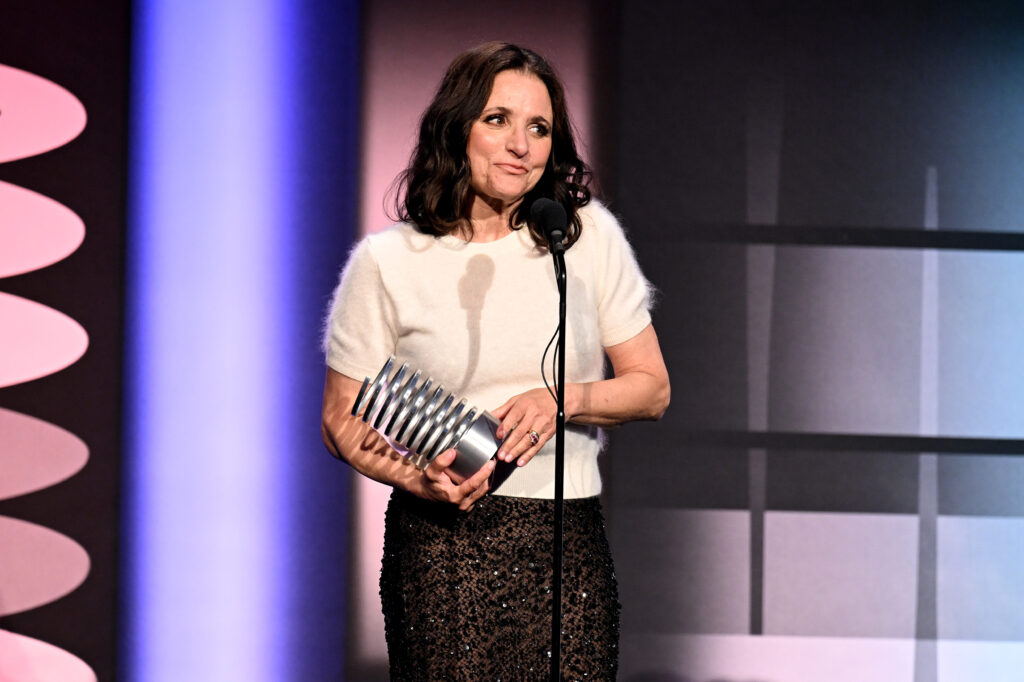 Julia Louis-Dreyfus accepts an award on stage.