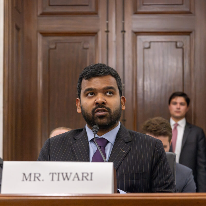 Udbhav Tiwari, Mozilla's Director of Global Product Policy, testifying at a Senate committee hearing on privacy and AI, seated at a table with a microphone and nameplate.