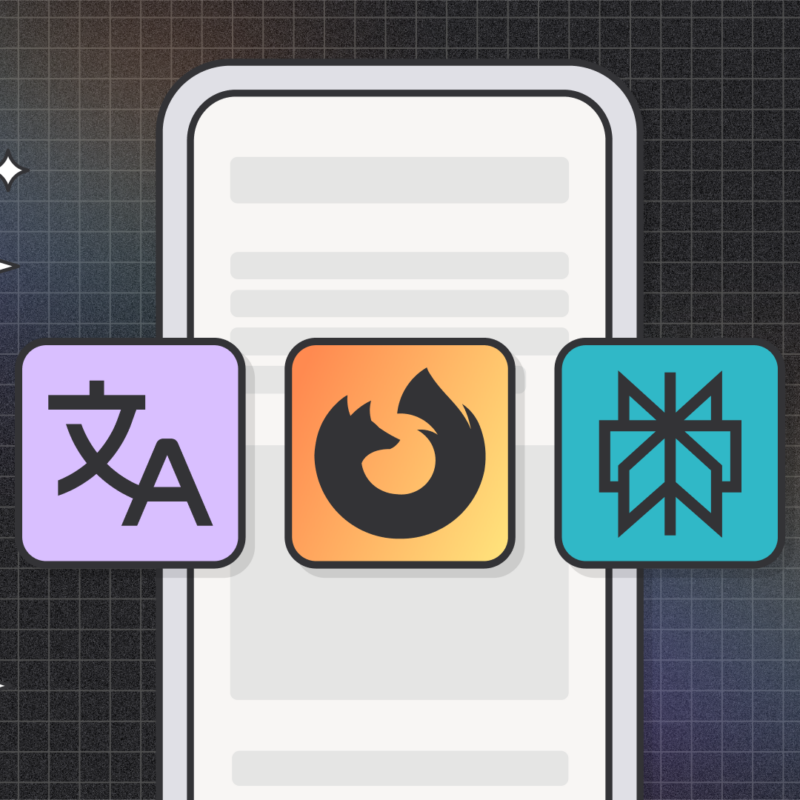 A stylized graphic showing a smartphone screen in the background with three square icons in front of it. The left icon is purple with a translation symbol, the middle icon is orange with the Firefox logo, and the right icon is teal with a geometric snowflake-like symbol. The background features a dark grid pattern with soft gradients and small star-like sparkles.
