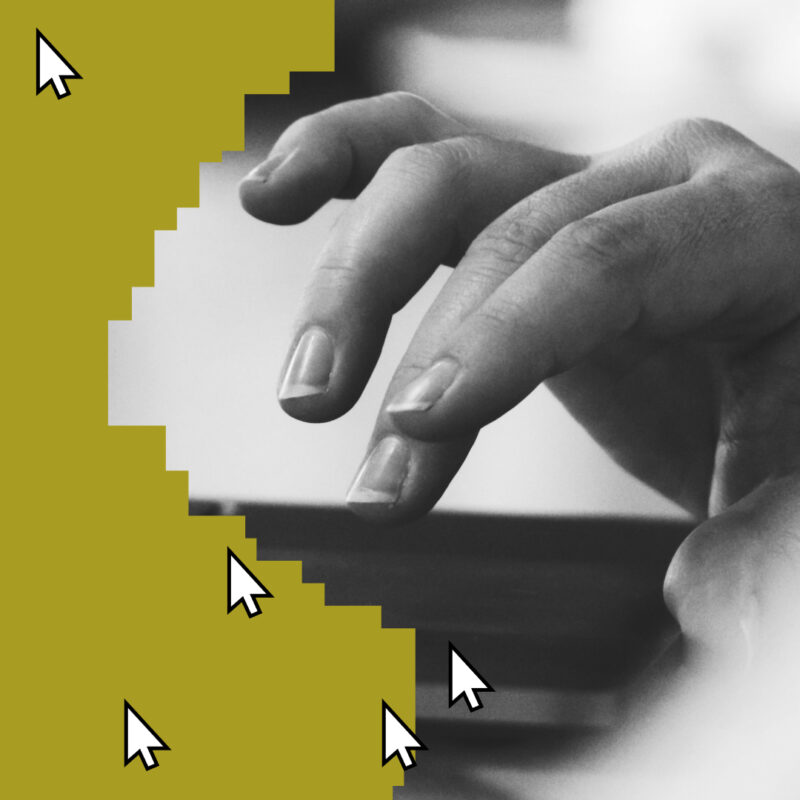 Black-and-white close-up of a hand using a device beside oversized cursor icons.